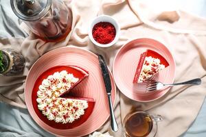 Premium Red Velvet cake and slice include cream, sugar with fork, cup of coffee and pot served on board isolated on napkin top view of cafe food photo