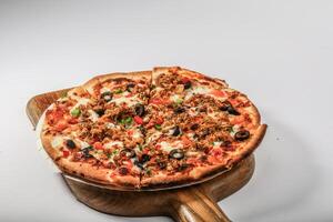 CHICKEN PIZZA topping with olive, chicken, tomato served in a cutting board isolated on grey background top view of arabian fastfood photo