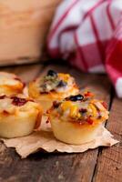 Assorted finger foods isolated on wooden table side view photo