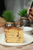 Salted Caramel Blondie cake slice include chocolate cream, sugar with fork, cup of coffee and pot served plate isolated on napkin side view of cafe food photo