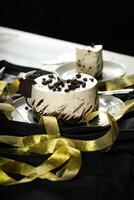 Oreo Cheesecake slice include chocolate, cream, sugar with fork and flowers served in plate isolated on napkin side view of cafe food photo