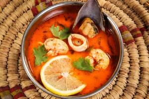 Tam Yum Soup with lemon served in bowl isolated on background top view arabic style photo