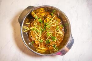 mutton karahi, Indian Lamb Curry, mutton bhuna masala served in karahi top view of pakistani food photo