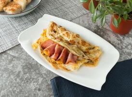 Bacon and Egg Scallion pancake Grabs pancake wrap served in dish isolated on napkin top view on table taiwan food photo