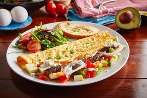 Zucchini omelette roll with salad served in a dish isolated on wooden background side view photo