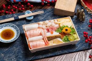 Mixed Fish Belly Don in a dish with chopsticks isolated on mat side view on wooden table taiwan food photo