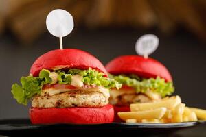 Mini chicken Burger with fries served in a dish isolated on grey background side view fast food photo