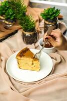 Salted Caramel Blondie cake slice include chocolate cream, sugar with fork, cup of coffee and pot served plate isolated on napkin side view of cafe food photo