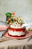 Premium Red Velvet cake include cream, sugar with fork, knife and flowers served in plate isolated on napkin side view of cafe food photo