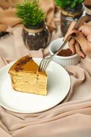 Salted Caramel Blondie cake slice include chocolate cream, sugar with fork, cup of coffee and pot served plate isolated on napkin side view of cafe food photo