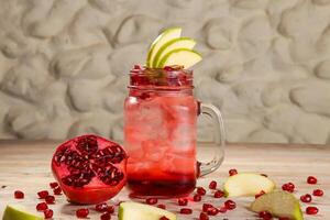 Arabic Style fresh pomegranate mojito with Pear fruit juices served in jar isolated on background top view drink photo