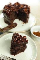 Chocolate Fudge Cake with fork and knife served in plate on food table top view cafe bake dessert photo