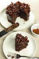 Chocolate Fudge Cake with fork and knife served in plate on food table top view cafe bake dessert photo