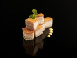 Roasted Pork Belly served in dish isolated on table top view of food photo
