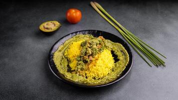 Fish fillet with lemon grass, lemon leaves and serve with rice and avocado salad served in dish isolated on table top view of arabic food photo