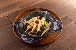 Chinese yam casserole with garlic core and black fungus served dish isolated on wooden table top view of Hong Kong food photo