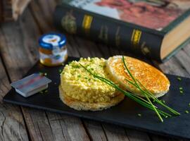 cheese scramble egg served in a dish isolated on cutting board side view of breakfast on wooden background photo