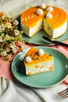 Mango Yogurt Cake slice topping with pistachio fork and flowers served in plate isolated on napkin side view cafe bake food photo