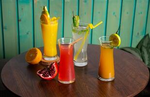 Assorted juices soda, cumin seeds water, watermelon juice shake with Spicy Lemonade, raw watermelon, straw isolated on wooden table side view healthy drink for vitamin c photo