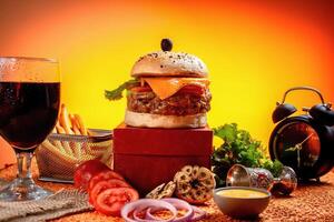 Tongue Twister Beef Naga burger with fries and tomato slice isolated on wooden board side view of american street food photo