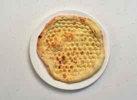 simple naan or sada naan served in a dish isolated on grey background top view of indian, pakistani food photo