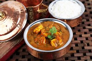 Prawns masala Kalya With Rice served in dish isolated on table side view of middle east food photo