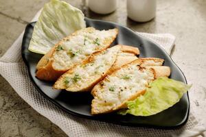 Garlic Cheese Bread served in a dish isolated on grey background side view fast food photo