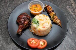 Chinese food set menu Fried rice, korean fried chicken, chicken skewer and tomato served in dish isolated on background top view of bangladesh and indian food photo