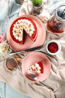 Premium Red Velvet cake and slice include cream, sugar with fork, cup of coffee and pot served on board isolated on napkin top view of cafe food photo