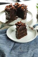 Chocolate Fudge Cake with fork and knife served in plate on food table top view cafe bake dessert photo