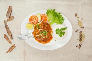 Mutton Raan masala with gravy and salad served in a dish isolated on table top view of indian spices food photo