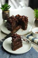 Chocolate Fudge Cake with fork and knife served in plate on food table top view cafe bake dessert photo