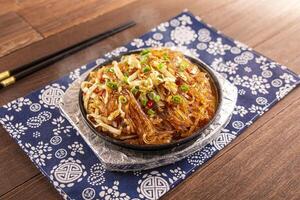 Sizzling Minced Meat Crystal Powder with noodles served dish isolated on wooden table top view of Hong Kong food photo