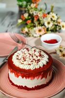 Premium Red Velvet cake include cream, sugar with fork, knife and flowers served in plate isolated on napkin side view of cafe food photo