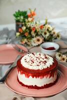 Premium Red Velvet cake include cream, sugar with fork, knife and flowers served in plate isolated on napkin side view of cafe food photo