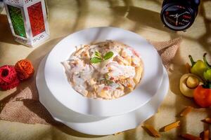 Creamy white dipped pasta in a plate side view on wooden background photo