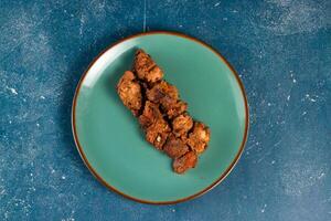 spicy bbq chicken tikka boti kabab served in a dish isolated on background top view photo