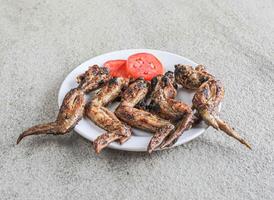 barbacoa pollo alas servido en un plato aislado en gris antecedentes lado ver de rápido comida foto