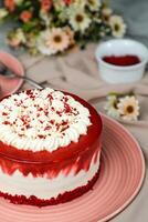 Premium Red Velvet cake include cream, sugar with fork, knife and flowers served in plate isolated on napkin side view of cafe food photo