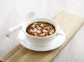 Seafood Hot and Spicy Soup with chopsticks served in a dish isolated on mat side view on grey background photo