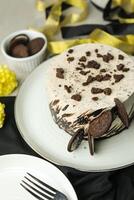 Oreo Cheesecake include chocolate, cream, sugar with fork and flowers served in plate isolated on napkin side view of cafe food photo