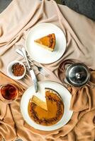 Salted Caramel Blondie cake slice include chocolate cream, sugar with fork, cup of coffee and pot served plate isolated on napkin top view of cafe food photo
