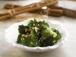 Sauteed Broccoli with Minced Garlic served dish isolated on background top view food photo