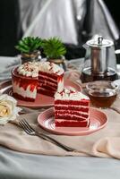 Premium Red Velvet cake and slice include cream, sugar with fork, cup of coffee and pot served on board isolated on napkin side view of cafe food photo