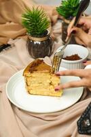 Salted Caramel Blondie cake slice include chocolate cream, sugar with fork, cup of coffee and pot served plate isolated on napkin side view of cafe food photo