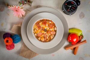 Creamy roma pasta with tomato in a plate top view on wooden background photo