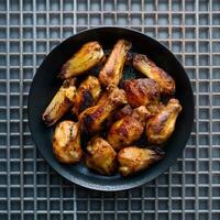 AI generated Grilled Chicken Wings Appetizing Display on Metal Grid Background For Social Media Post Size photo