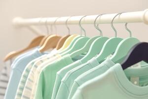 AI generated Kid friendly pastels Shirts hanging on rack, soft and inviting photo