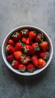 AI generated Vibrant Organic Strawberries White Dish on Muted Gray Background Vertical Mobile Wallpaper photo