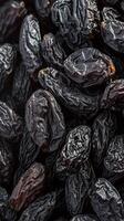 AI generated Sweet and chewy Texture of black raisins, a beloved dried fruit Vertical Mobile Wallpaper photo